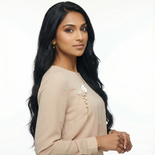 Model wearing elegant floral pearl brooch and statement jewelry set